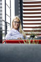 Smiling businesswoman sitting on sofa