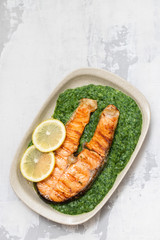 grilled salmon with lemon and spinach on dish