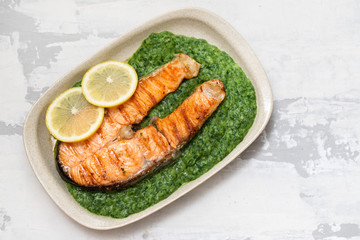 grilled salmon with lemon and spinach on dish
