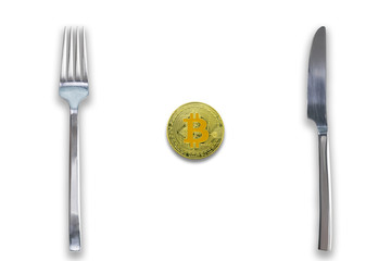 One Bitcoin crypto currency between fork and knife. Concept of Bitcoin scalability problem. Cryptocurrency market deficit and limitations. Isolated white background.
