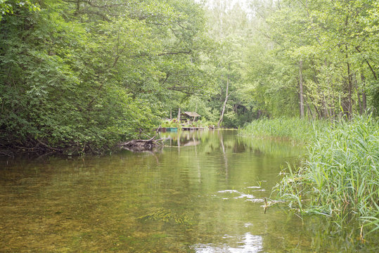 Beautiful river in a forest. Summerhouse near the river bank. Lithuania, Ignalina, Meironys, Meira river.