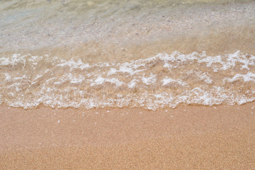 Background of Sand and sea wave at the beautiful beach in summer  holiday 