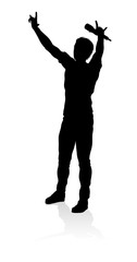 A singer pop, country music, rock star or hiphop rapper artist vocalist singing in silhouette