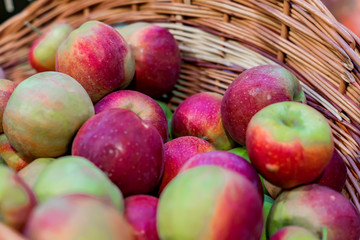 close up of red ripe apples in a basket at the farmer's market