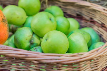 close up of green ripe apples in a basket at the farmer's market