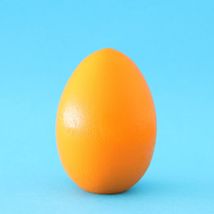 concept image of egg shape over blue pastel background. minimal an pop art concept.