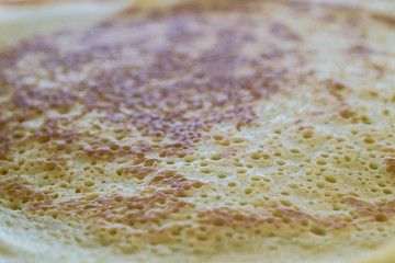 texture of the finished pancake with a lot of holes in the foreground