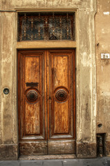 Fototapeta na wymiar Tuscan wooden doorway and wall, Certaldo