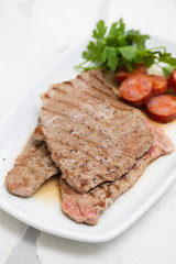 grilled meat with smoked sausage on white dish