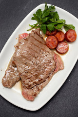 grilled meat with smoked sausage on white dish