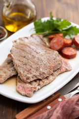grilled meat with smoked sausage on white dish