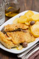 cod fish with fried potato on white dish