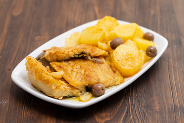 cod fish with fried potato on white dish