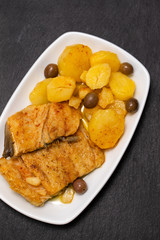 cod fish with fried potato on white dish