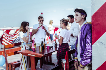Deep in thoughts. Group of young people celebrating state holiday and testing alcohol drinks