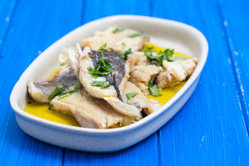 boiled cod fish with herbs and olive oil