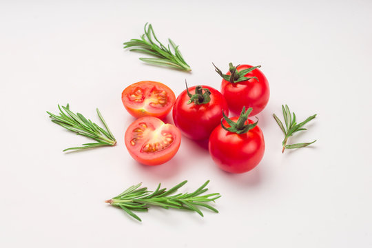 Cherry tomatoes with rosemary from above on white