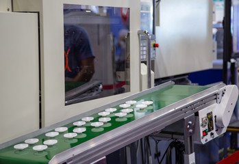 Product of plastic gears from electric injection molding machine. Industry plastic manufacturing	