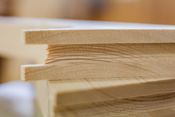 Eco friendly woodworker's shop. Details and focus on the texture of the material, saw dust, and planers or chisels, while making legs for a designer coffee table. Mastering wood with peacefullness.