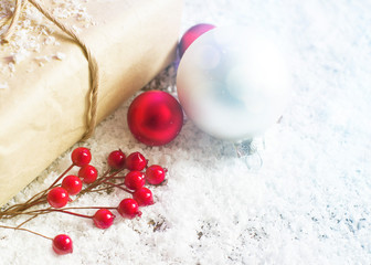 Obraz na płótnie Canvas New Year's fir-tree toys, glass balls on a snow surface, soft focus. Christmas decoration