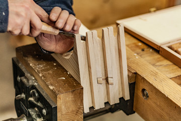 Eco friendly woodworker's shop. Details and focus on the texture of the material, saw dust, and...
