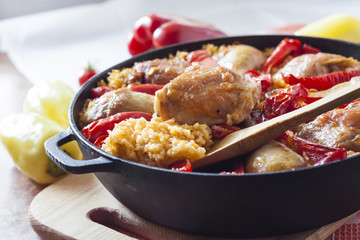 Chicken thighs and legs baked over a bed of rice and red bell pepper