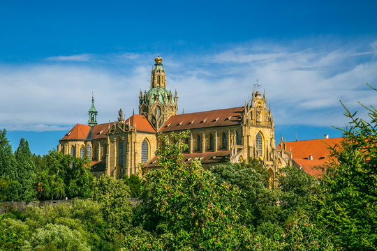 Monumental monastery of Benedictines in Kladruby, Czech Republic, Europe from 12th century standing on hill, includes church of All Saints, red roof, green foreground, sunny summer day, blue sky