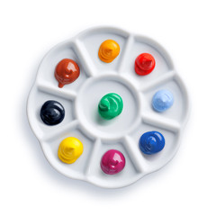 Palette with paints isolated on white