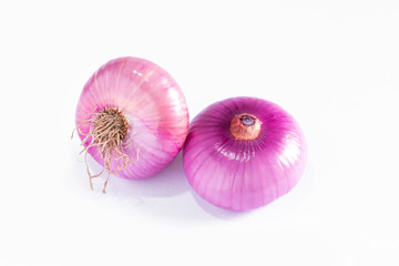 Allium cepa L. Red Onion with dry rootlet isolated on white floor.