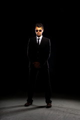 A serious man in a black suit.