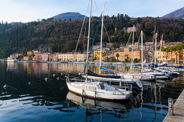 Various boats at the lake Garda, as seen from the coast of the town of Toscolano Maderno in Italy