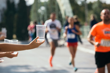 taking water from volunteer. marathon concept
