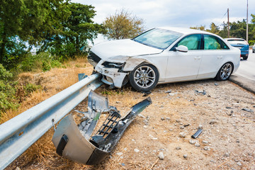 Crashed car with deflated airbags after accident finished on road crashed barrier