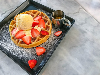 strawberry pancake and syrup cup on black bowl