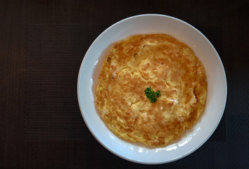 Yellow fried chicken eggs  or omelet served in white plate on the table cloth