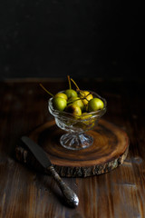 Wild pear in a glass bowl on a wooden close background. Rustic concept