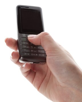 Closeup of Hand Using an Old Mobile Phone