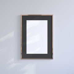 Copper blank frame on the light gray wall. Frame mock up.
