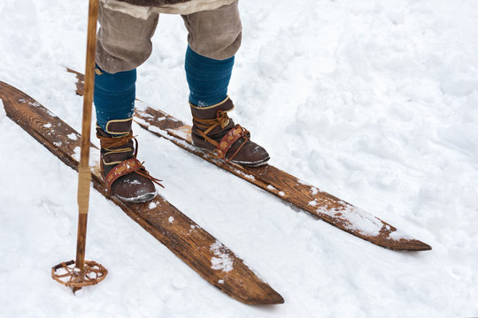 Male feet ancient skier and vintage skis. Historical reconstruction