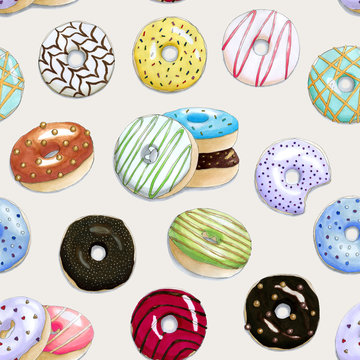 Seamless pattern with the hand painted colorful donuts on a beige background