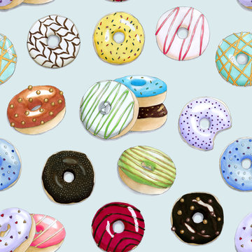 Seamless pattern with the hand painted colorful donuts on a light blue background