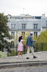 A couple of lovers walk in the streets of Montmartre in Paris