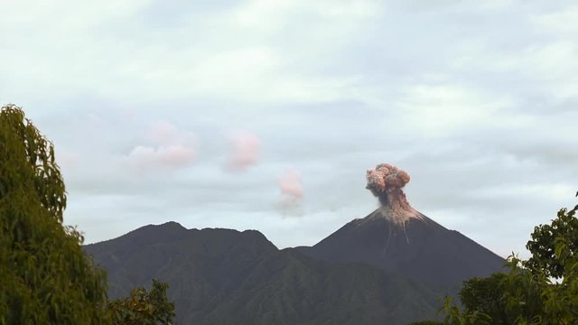 Reventador Volcano erupting at dawn, November 2015. The mountain is situated in a remote part of the Ecuadorian Amazon surrounded by rainforest. Red hot rocks roll down the mountainside.