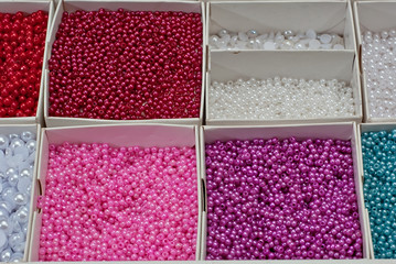 close up multi colored beads heap in box