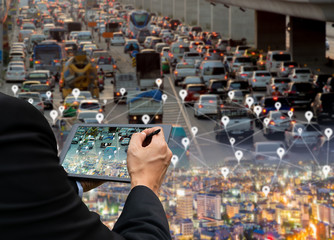 Businessman holds a tablet car on the road network technology of digital map in the city