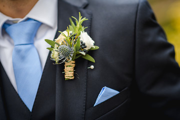 Natural flowers boutonniere in the pocket of the groom - obrazy, fototapety, plakaty