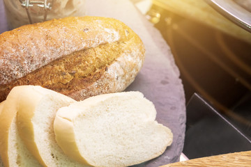 The roast bread and slice bread on the disk with morning light.