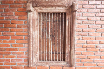 The old wooden window  on the background of brick walls