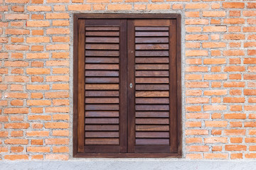 Wooden window on a brick wall