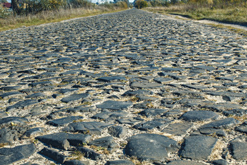 The road is made of stones. Background of the road